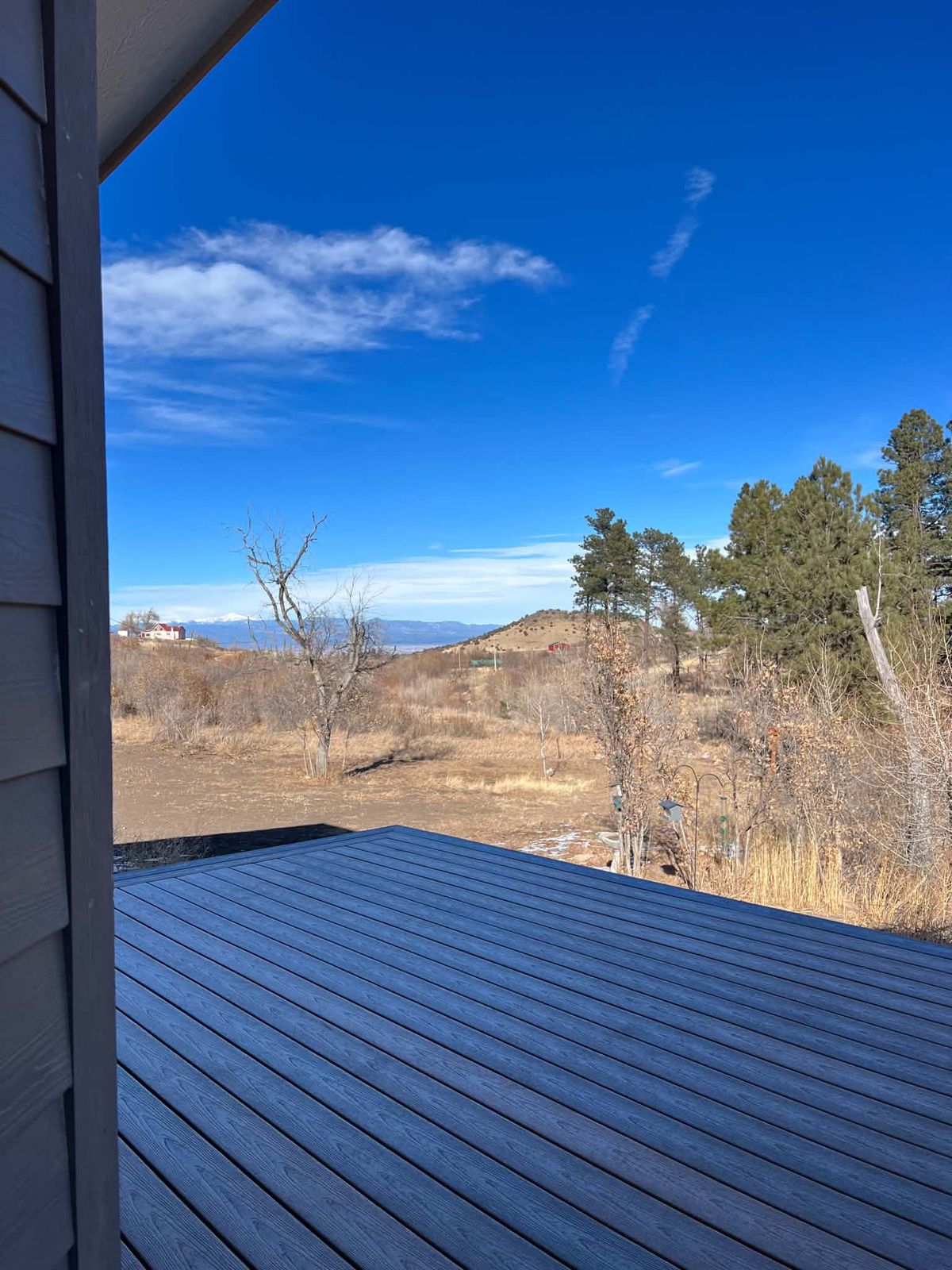 Dark composite deck looking out over foothills and pines